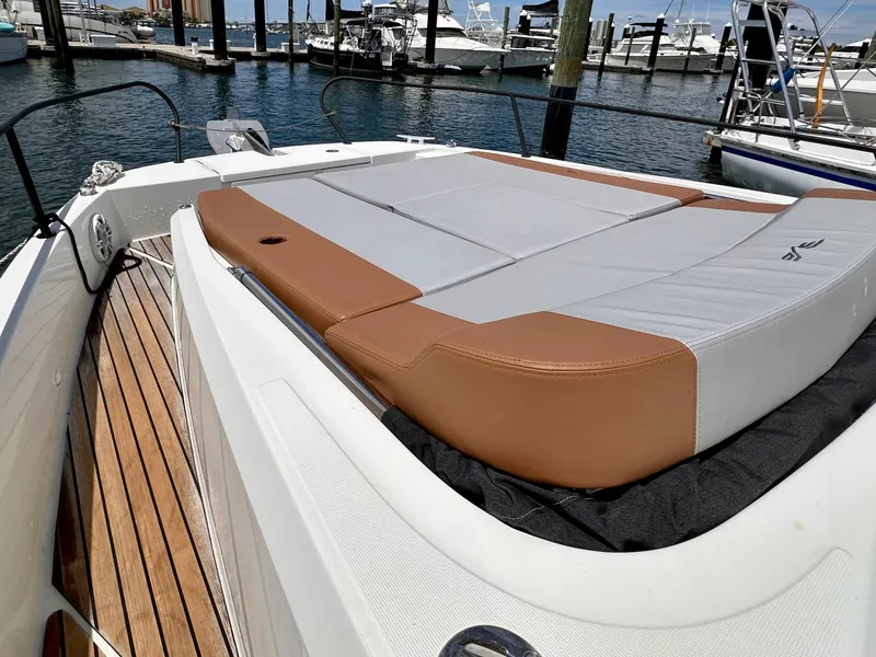 Slide: The Image of 2023 Beneteau Flyer 9 SUNdeck with cushioned sunbathing area, docked at marina. - 15