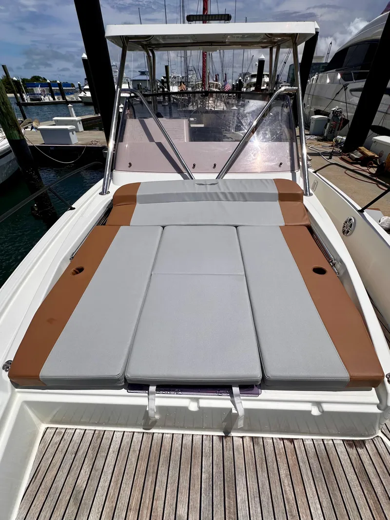 Slide: The Image of 2023 Beneteau Flyer 9 SUNdeck with cushioned sunbathing area at marina. - 16
