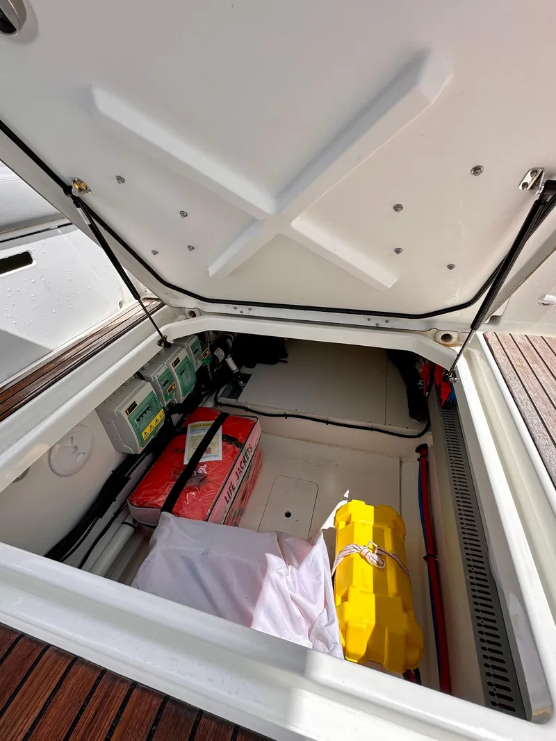 Slide: The Image of Open storage compartment of 2023 Beneteau Flyer 9 SUNdeck boat, showing equipment and supplies. - 17