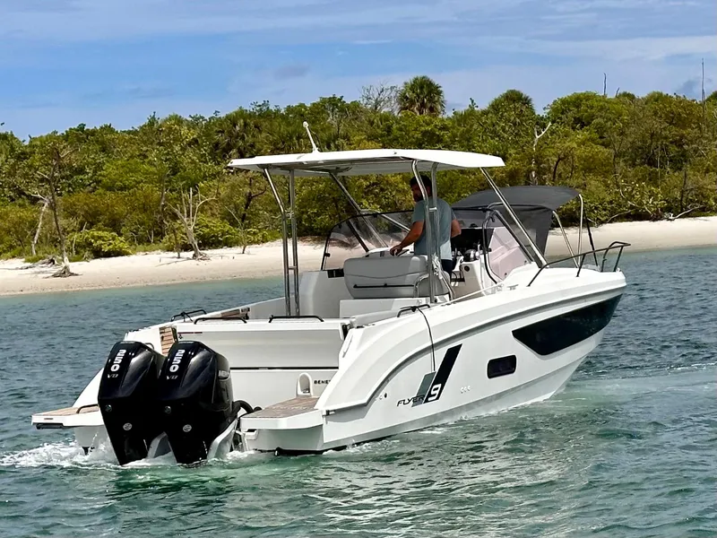 Slide: The Image of 2023 Beneteau Flyer 9 SUNdeck cruising near a sandy shoreline. - 3