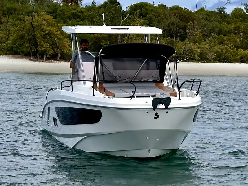 Slide: The Image of 2023 Beneteau Flyer 9 SUNdeck boat on water near a sandy beach. - 5
