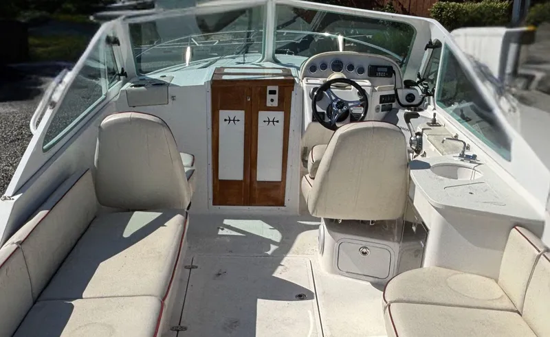 Slide: The Image of 2015 Hunt Yachts Harrier 25 Sport interior with seating, steering wheel, and dashboard. - 11
