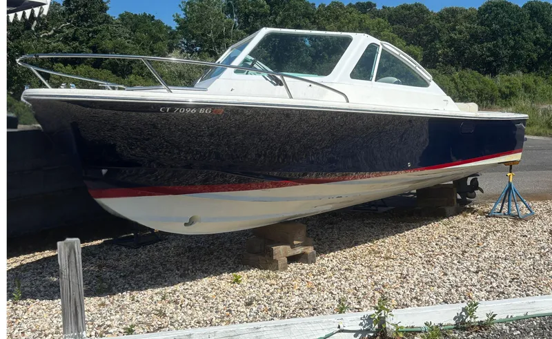 Slide: The Image of 2015 Hunt Yachts Harrier 25 Sport boat on dry land, surrounded by trees. - 5