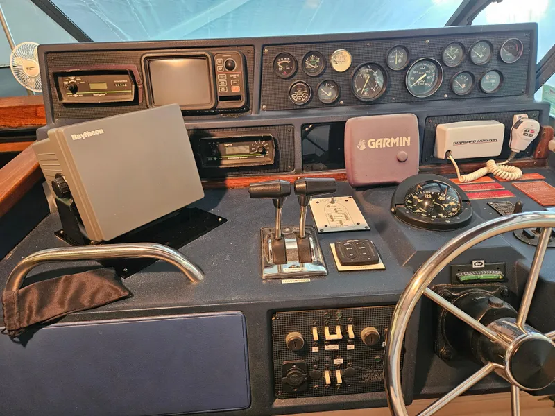 Slide: The Image of Dashboard of a 1989 Sea Ray 390 Express with navigation equipment and controls. - 10