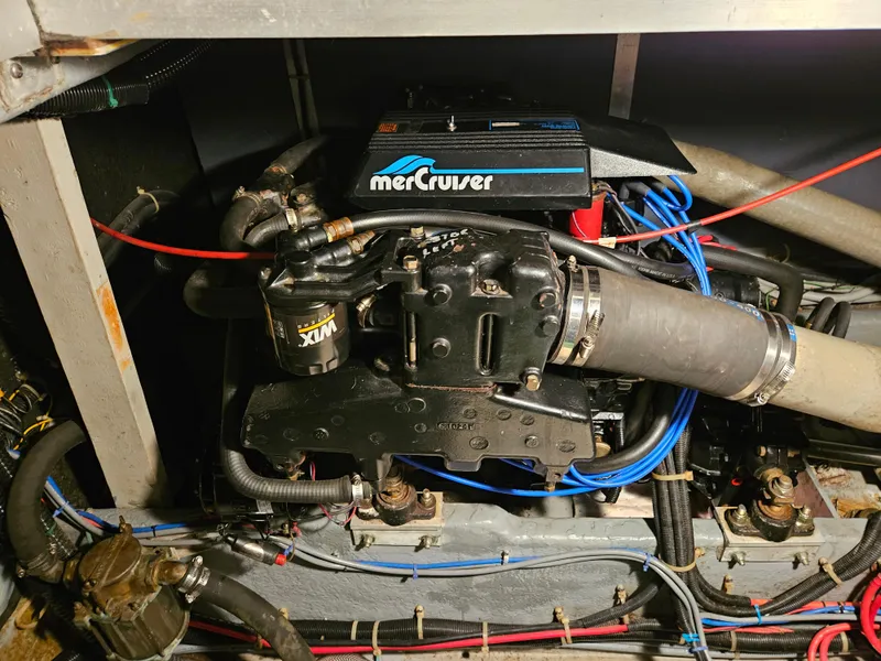 Slide: The Image of 1989 Sea Ray 390 Express engine compartment with MerCruiser components. - 12