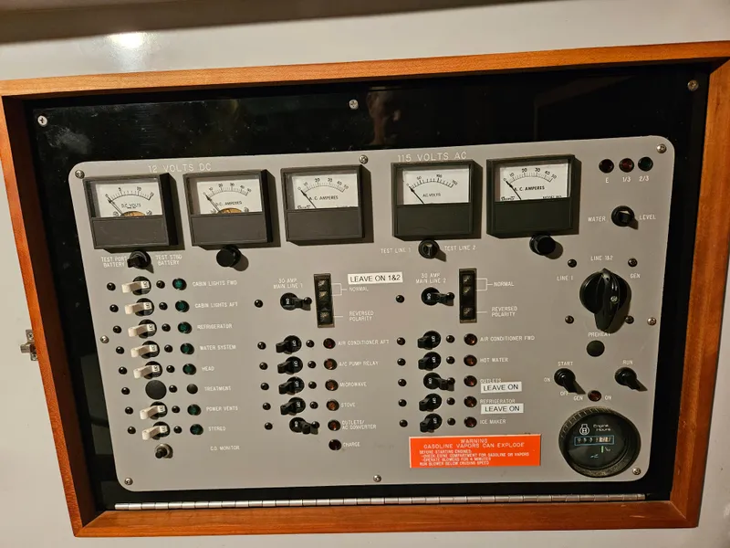 Slide: The Image of Control panel of a 1989 Sea Ray 390 Express boat with gauges and switches. - 13