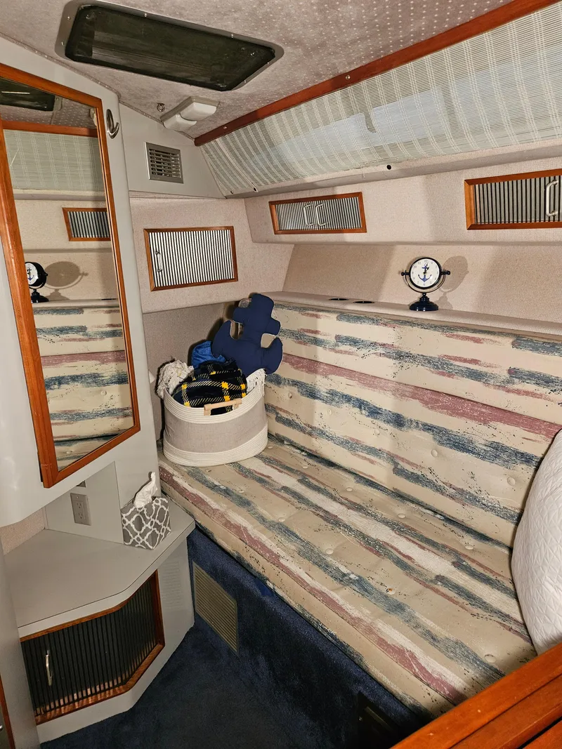 Slide: The Image of Interior of 1989 Sea Ray 390 Express with striped seating and nautical decor. - 20