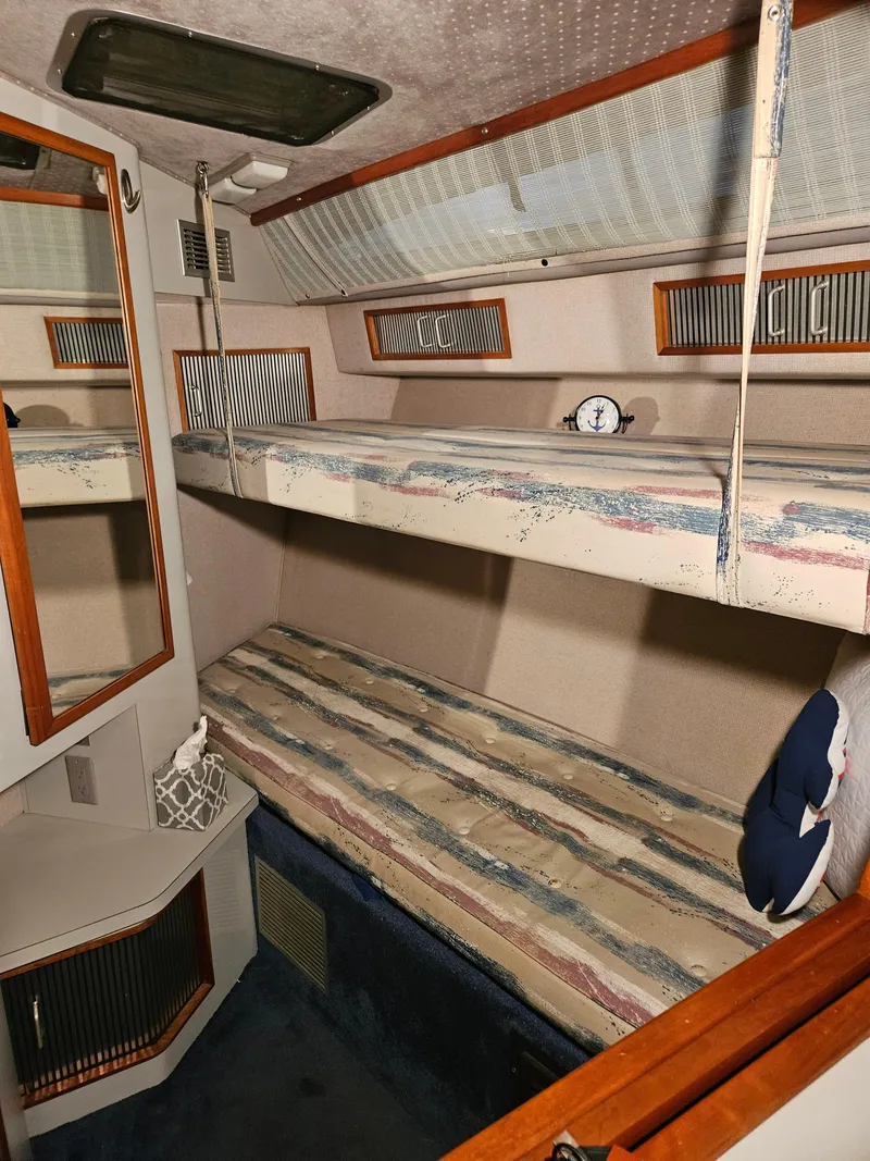 Slide: The Image of 1989 Sea Ray 390 Express cabin with bunk beds and nautical decor. - 21