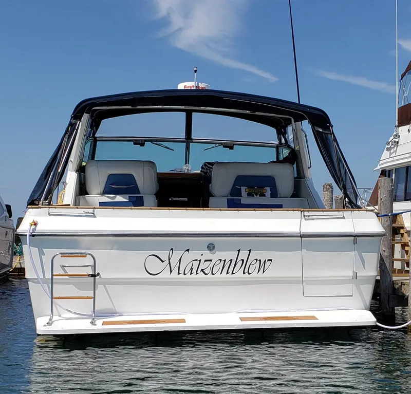 Slide: The Image of 1989 Sea Ray 390 Express boat named "Maizenblew" docked in a marina. - 3