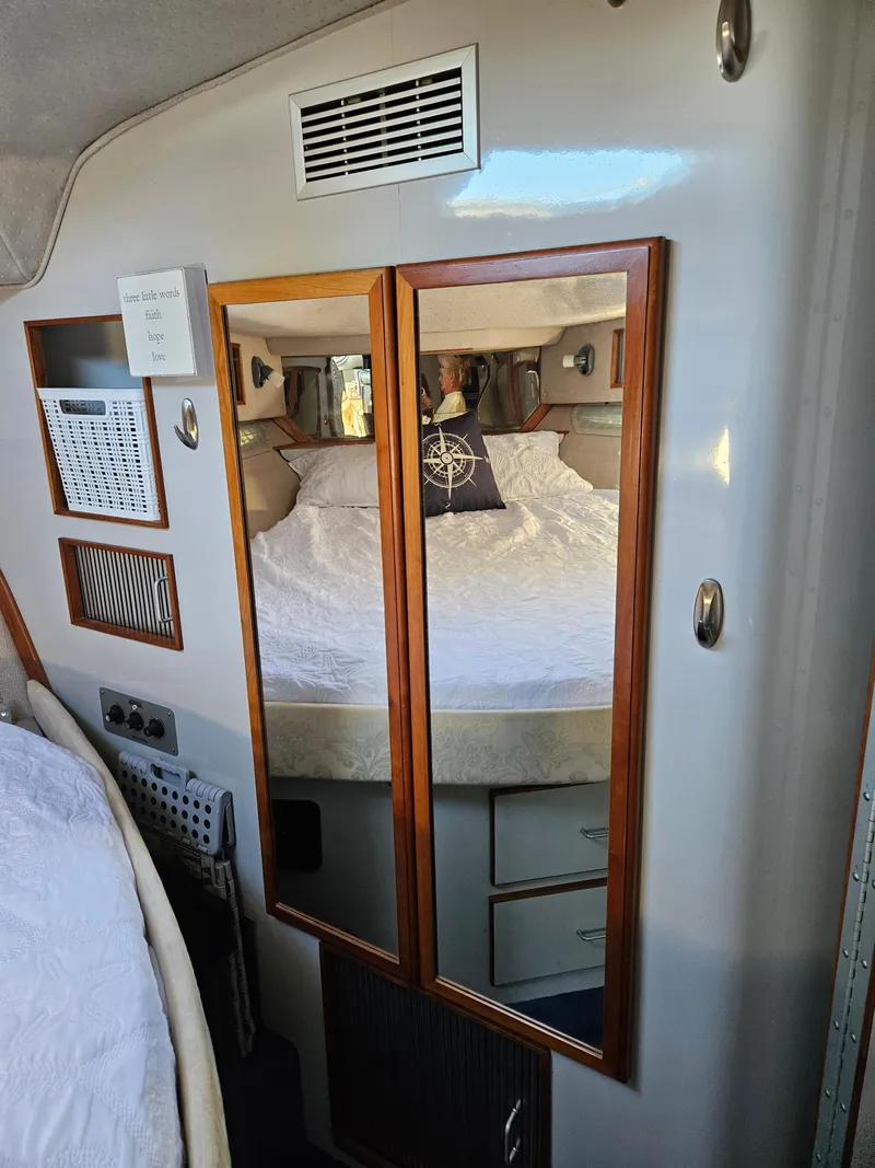Slide: The Image of Interior cabin of 1989 Sea Ray 390 Express with mirrored closet and cozy bed. - 33