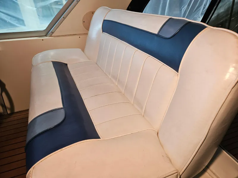 Slide: The Image of 1989 Sea Ray 390 Express interior with blue and white seating. - 8