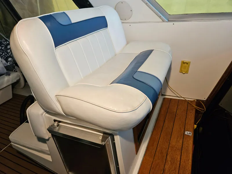 Slide: The Image of White and blue seating on 1989 Sea Ray 390 Express boat interior. - 9