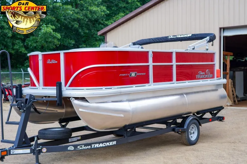 The Image of 2026 Sun Tracker Party Barge 16 pontoon boat on trailer, red and silver design. - 0
