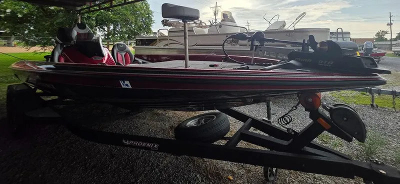 Slide: The Image of Storage compartment in a 2018 Phoenix 819 Pro boat, featuring a clear container inside. - 10