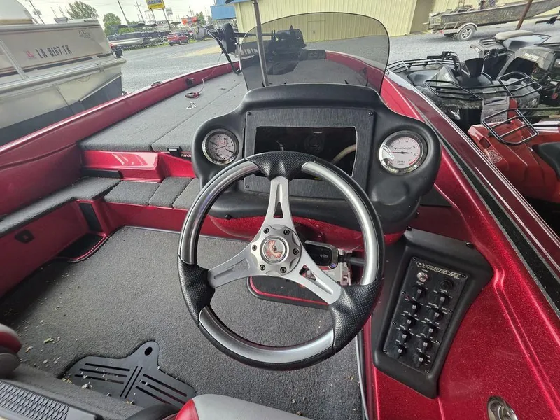 Slide: The Image of 2018 Phoenix 819 Pro boat interior with red and gray seats, steering wheel, and dashboard. - 14