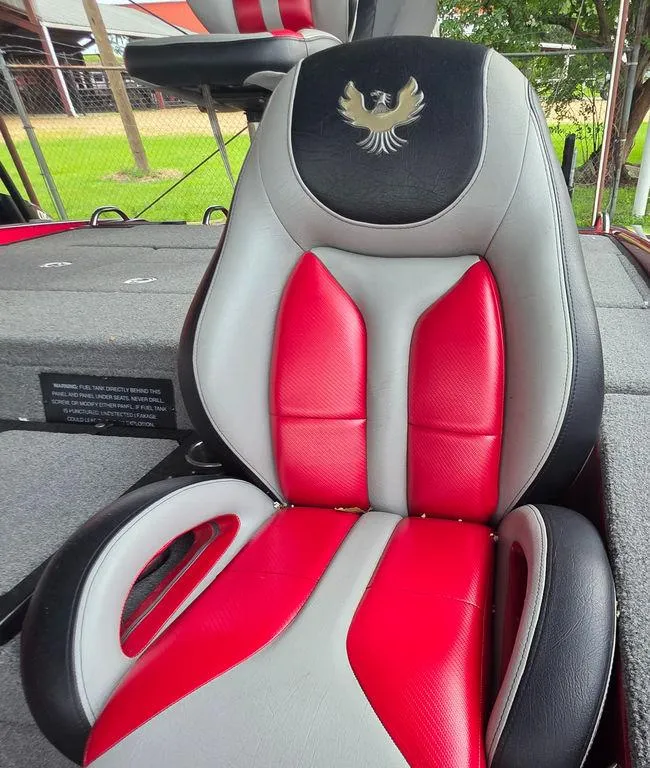 Slide: The Image of 2018 Phoenix 819 Pro fishing boat with red accents, parked at Bryan's Marine dealership. - 16