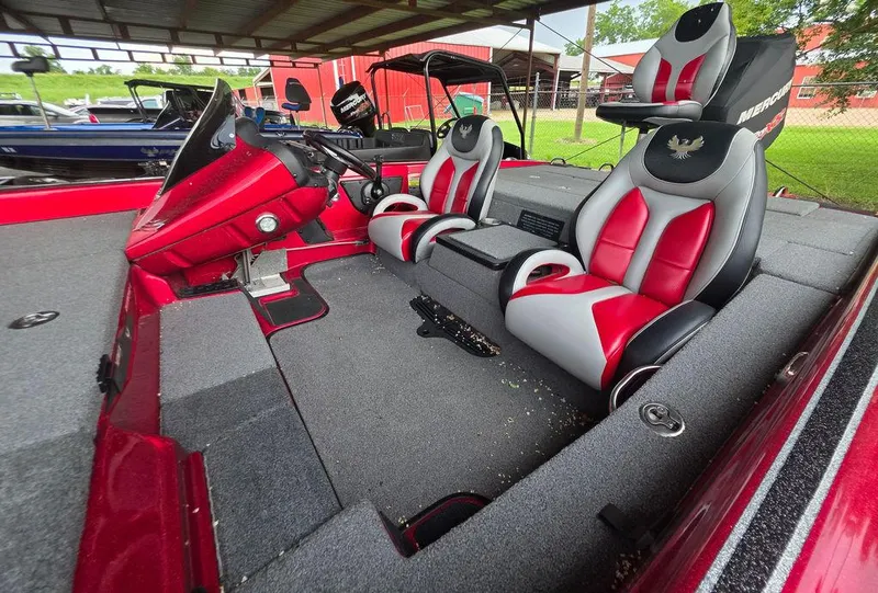Slide: The Image of 2018 Phoenix 819 Pro boat interior with red and black seats, steering wheel, and control panel. - 2