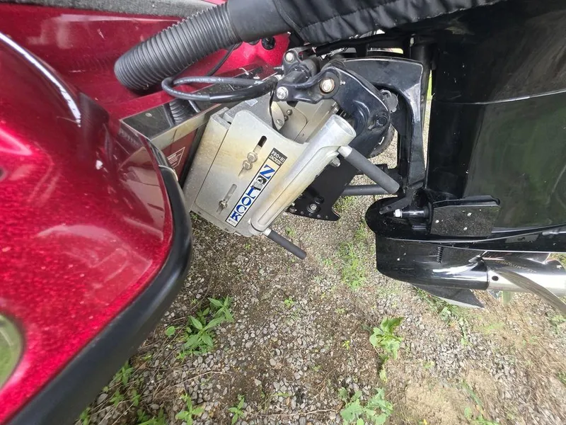 Slide: The Image of 2018 Phoenix 819 Pro bass boat with red accents, parked under a canopy. - 3