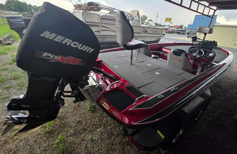 Slide: The Image of 2018 Phoenix 819 Pro boat storage compartment with red trim and rod holders. - 5