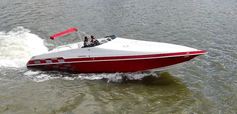 Slide: The Image of 1995 Fountain 38 Sport Cruiser speeding on water, red and white design. - 0