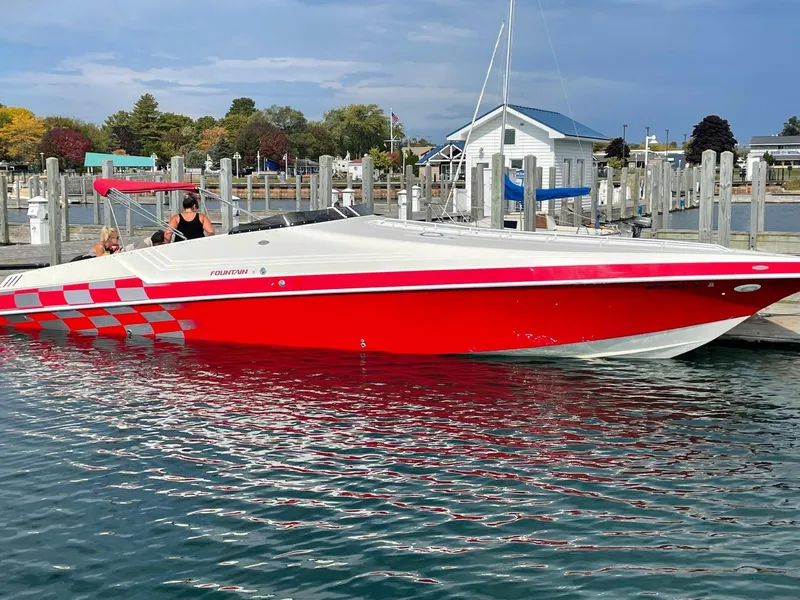 Slide: The Image of Red and white 1995 Fountain 38 Sport Cruiser docked at a marina. - 1