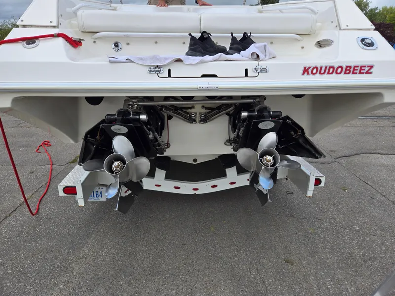 Slide: The Image of 1995 Fountain 38 Sport Cruiser boat with dual propellers, docked on concrete. - 12