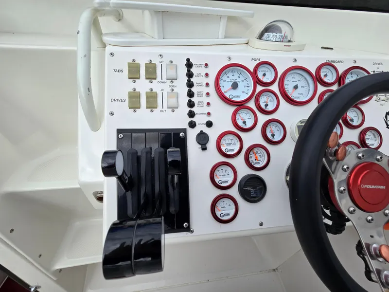 Slide: The Image of Control panel of a 1995 Fountain 38 Sport Cruiser with gauges and steering wheel. - 30