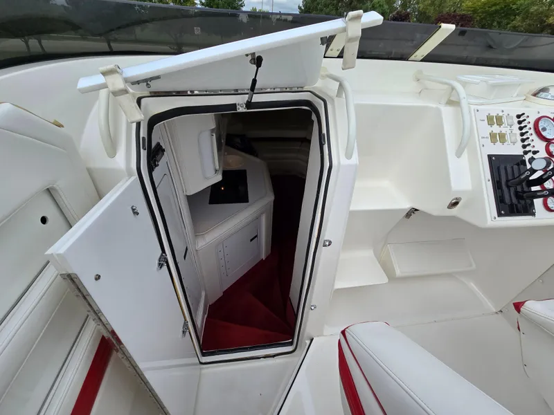 Slide: The Image of 1995 Fountain 38 Sport Cruiser cabin entrance with white interior and red accents. - 34