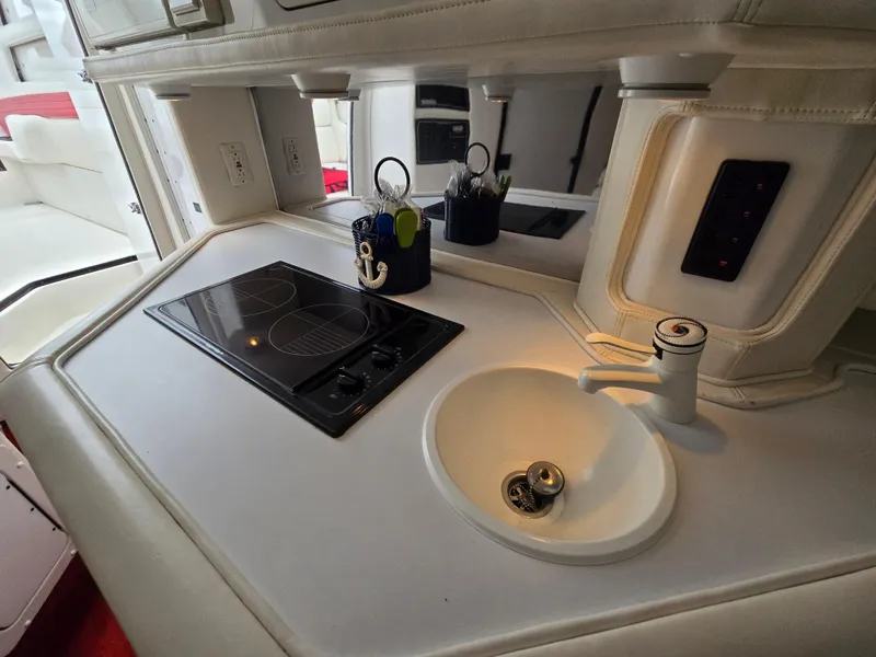 Slide: The Image of 1995 Fountain 38 Sport Cruiser kitchen with stove and sink. - 39