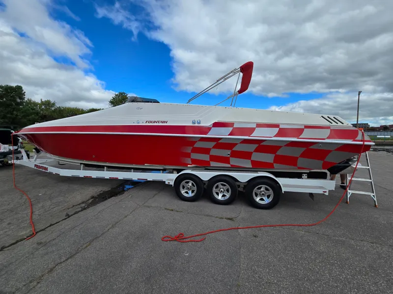 Slide: The Image of 1995 Fountain 38 Sport Cruiser with red and white checkered design on trailer. - 5