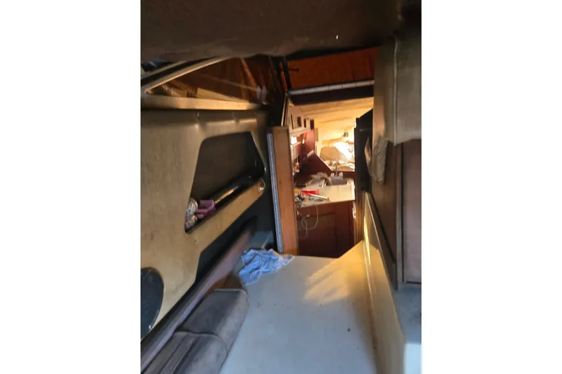 Slide: The Image of Interior view of 1983 Sea Ray Weekender boat cabin with seating and storage. - 16