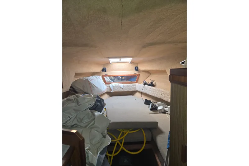 Slide: The Image of Interior of a 1983 Sea Ray Weekender boat cabin with seating and storage. - 18