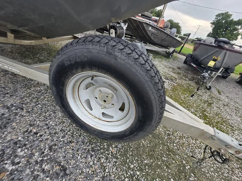 Slide: The Image of Trailer tire of 2016 Xpress Xclusive Series X18 boat on gravel surface. - 13