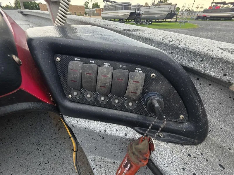 Slide: The Image of Control panel of 2016 Xpress Xclusive Series X18 boat with switches and keychain. - 8