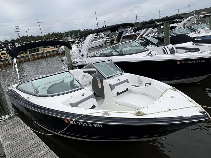 The Image of 2015 Monterey 224FS boat docked at marina, featuring sleek design and comfortable seating. - 1