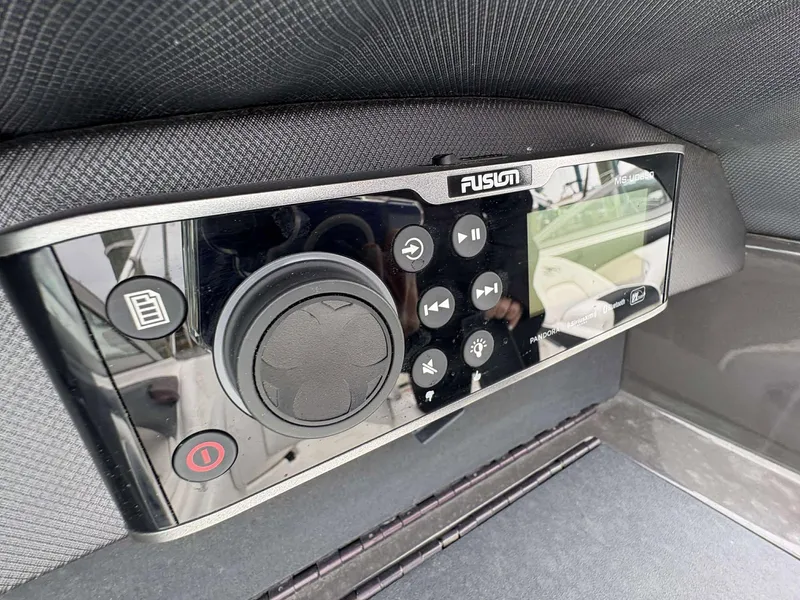 Slide: The Image of Fusion audio system controls on a 2015 Monterey 224FS boat dashboard. - 10