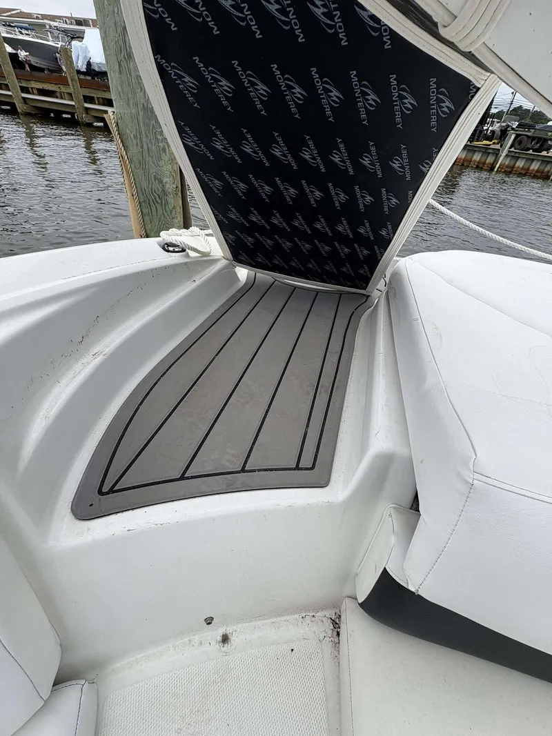 Slide: The Image of 2015 Monterey 224FS boat interior with cushioned seating and non-slip flooring. - 12