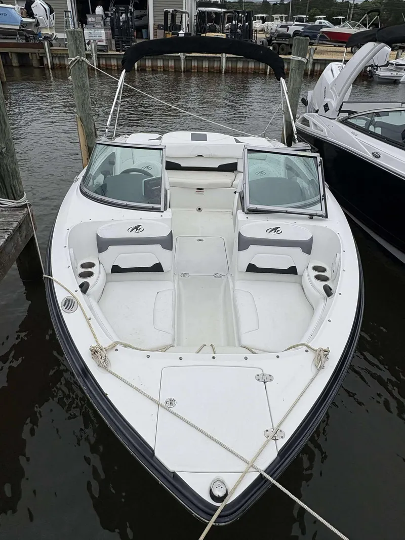 Slide: The Image of 2015 Monterey 224FS boat docked, featuring open bow seating and sleek design. - 3