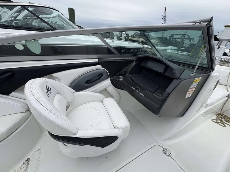 Slide: The Image of 2015 Monterey 224FS boat interior with white seating and dashboard. - 8