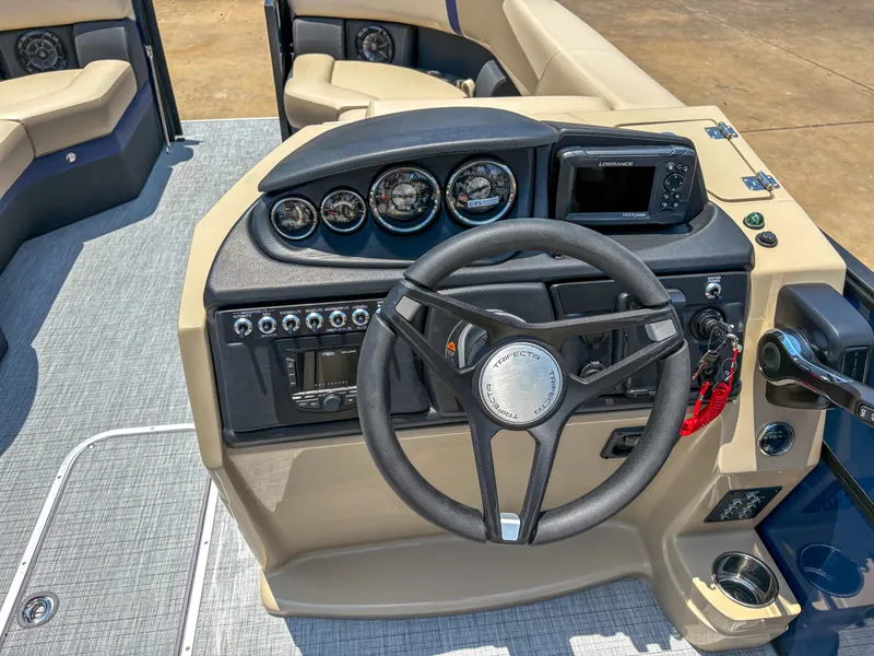 Slide: The Image of 2025 Trifecta CS 24RF 3.0 boat dashboard with steering wheel and control panel. - 11