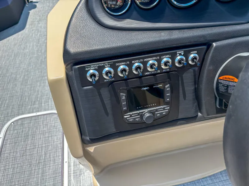 Slide: The Image of Control panel of 2025 Trifecta CS 24RF 3.0 boat with switches and audio system. - 12
