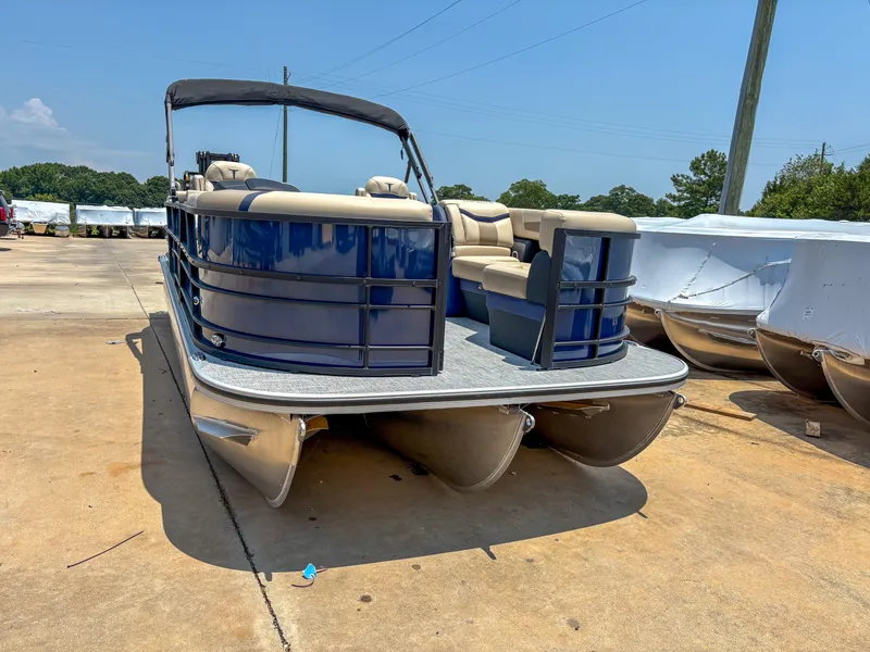 Slide: The Image of 2025 Trifecta CS 24RF 3.0 pontoon boat on display in a sunny outdoor setting. - 2