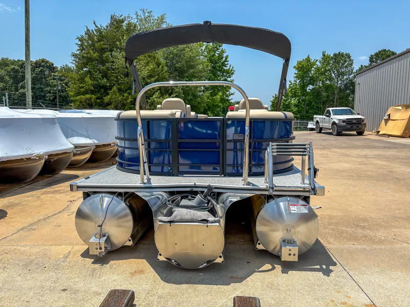 Slide: The Image of 2025 Trifecta CS 24RF 3.0 pontoon boat on a sunny day, parked outdoors. - 3