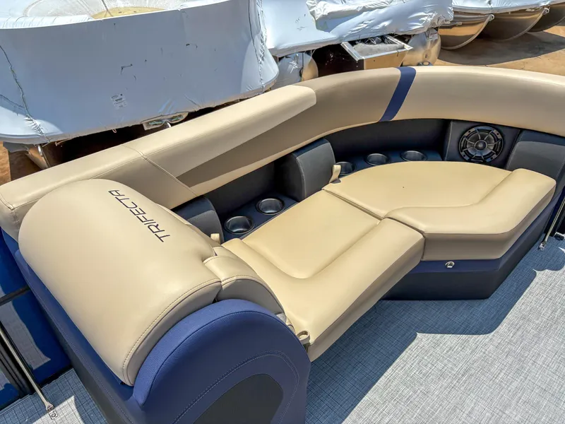 Slide: The Image of 2025 Trifecta CS 24RF 3.0 boat interior with beige seating and cup holders. - 5