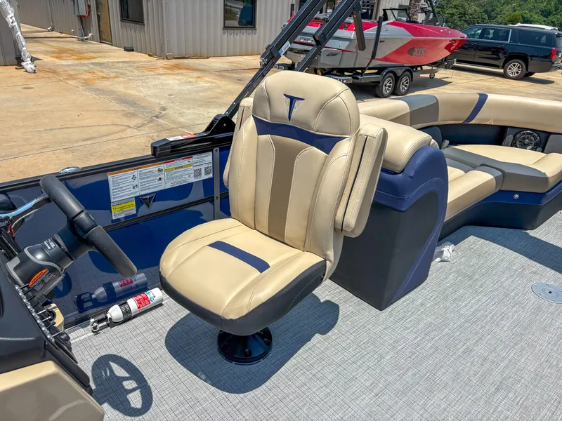 Slide: The Image of 2025 Trifecta CS 24RF 3.0 boat interior with beige and blue seating. - 8