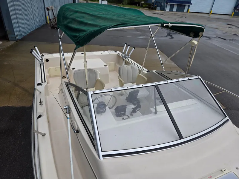 Slide: The Image of 1997 Pro-Line 201 Walkaround boat with green canopy and dual seats. - 16