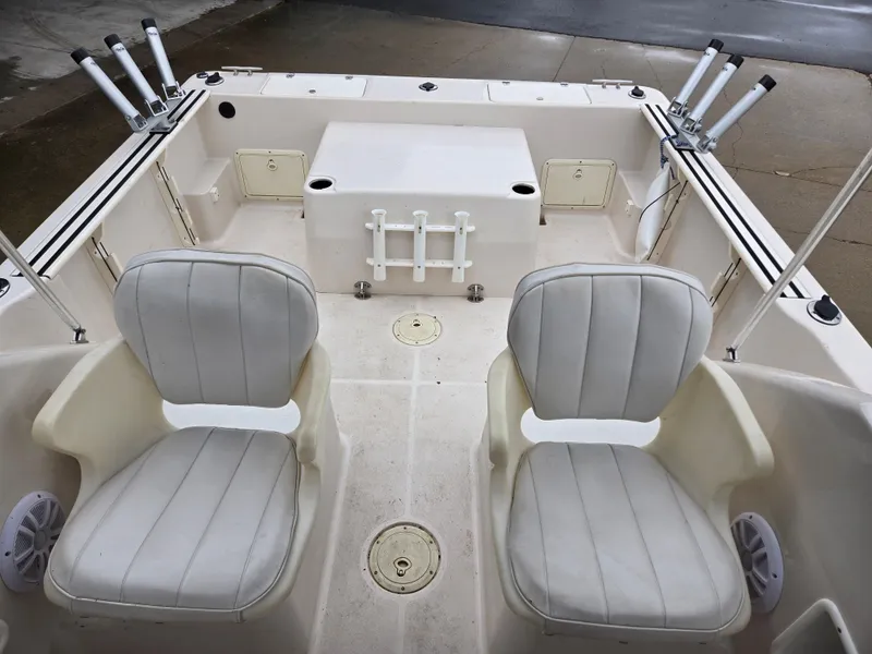 Slide: The Image of 1997 Pro-Line 201 Walkaround boat interior with dual seats and rod holders. - 18