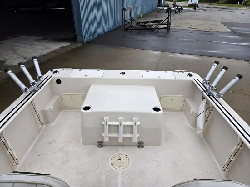 Slide: The Image of 1997 Pro-Line 201 Walkaround boat deck with rod holders and storage compartments. - 19