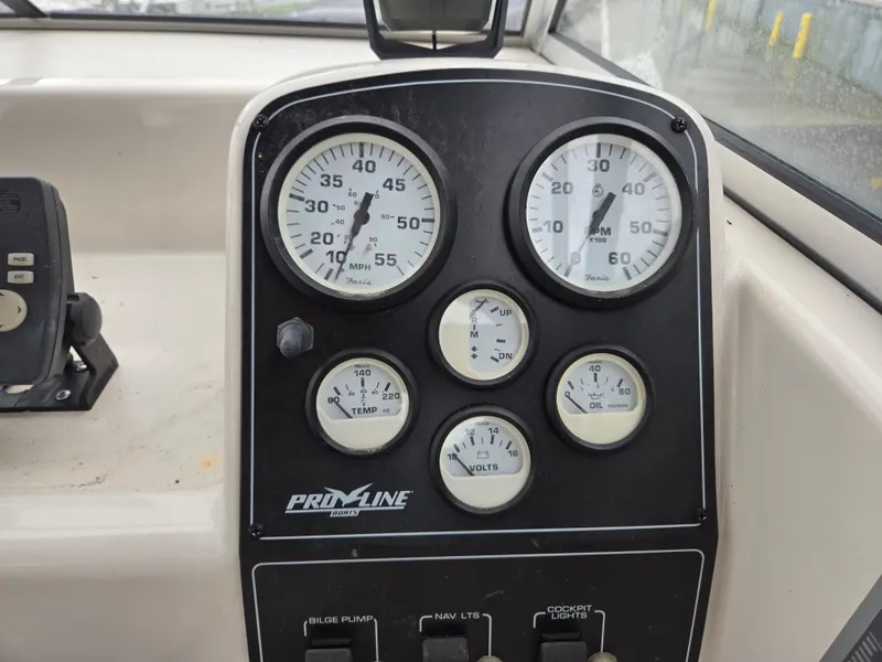Slide: The Image of 1997 Pro-Line 201 Walkaround dashboard with gauges and controls. - 21