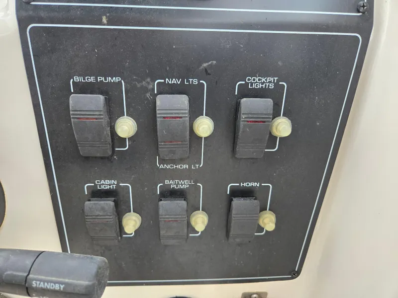 Slide: The Image of Control panel of a 1997 Pro-Line 201 Walkaround boat with various switches. - 22